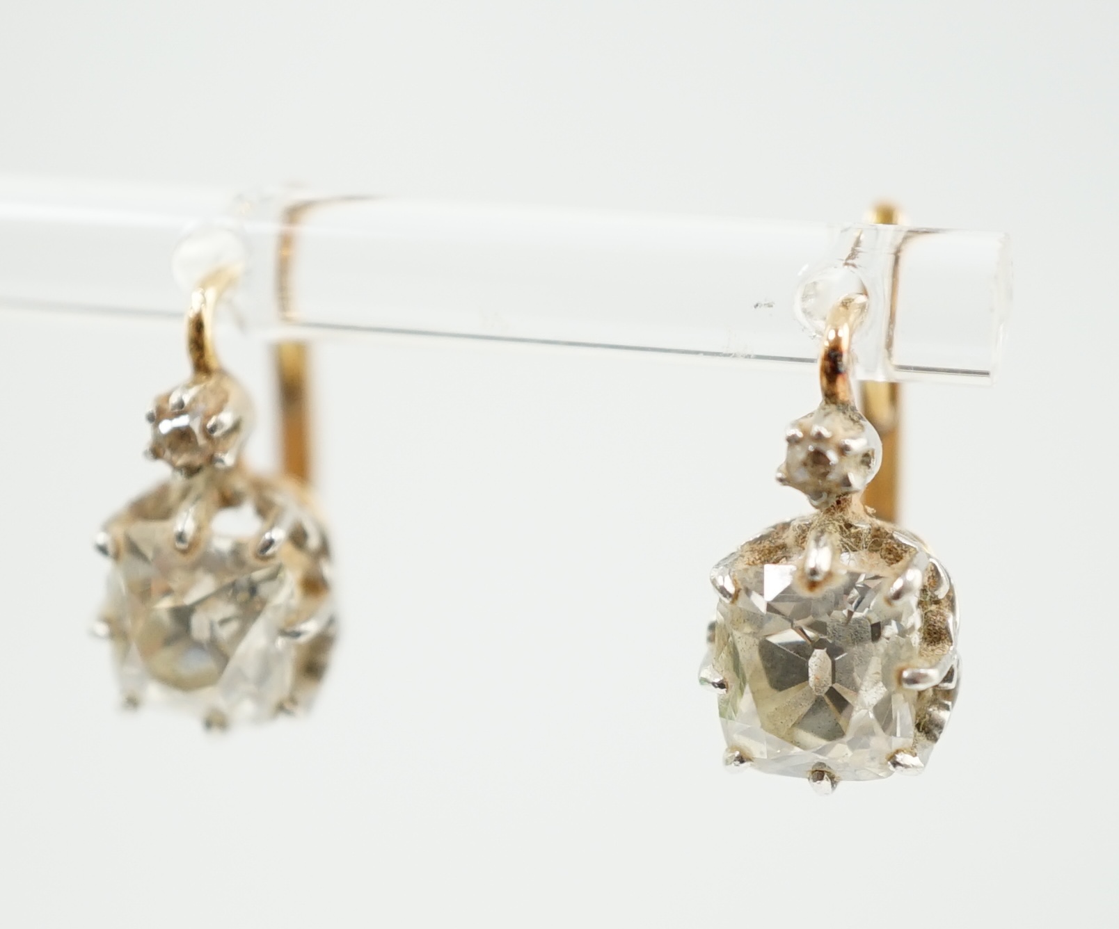 A pair of late 19th/early 20th century gold and two stone cushion cut diamond set earrings
